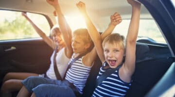 Kids having fun in car on a road trip