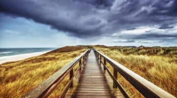 Autumn on Sylt - Wooden path under dramatic sky