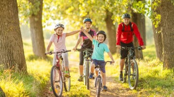 Happy family cycling in the countryside