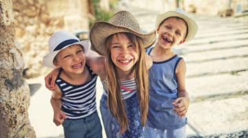 Kids having fun visiting the beautiful Majorcan town of Pollenca