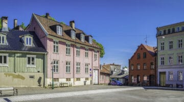 Colourful townhouses villas and homes overlooking sunny square Oslo Norway