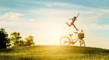 Woman enjoy holiday in the park. She was jumping happiness